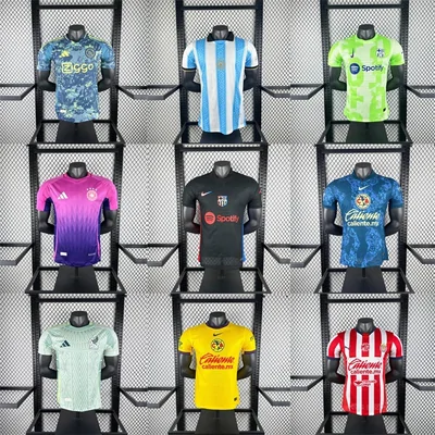 Nine football shirts in club colours displayed in three rows on a black wire rack